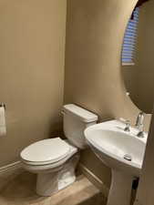 Bathroom with mirror, light tile flooring, and sink