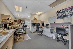Carpeted office space with TV