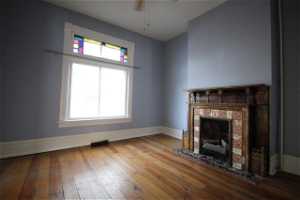 Original Victorian era fireplace now has gas log inserts.  This room would have traditionally been called the parlor and has double doors separating it from the entry and pocket doors separating it from the living room.  Works well as an office, formal di