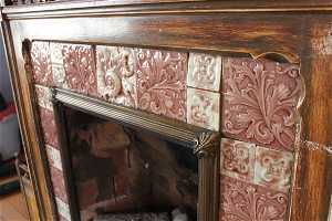 Detail of original Victorian art tiles at the fireplace surround downstairs.