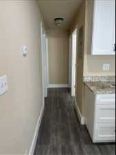 Hallway leading from kitchen to rooms and bathroom