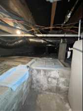 View of basement area behind water softener and water heater