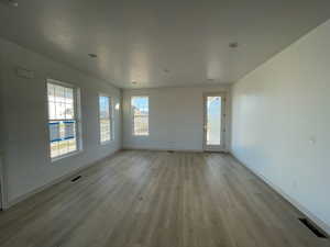 Empty room featuring light hardwood floors