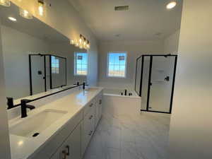 Bathroom with independent shower and bath, dual vanity, mirror, and light tile floors