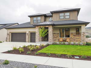 Prairie-style house featuring garage and a front lawn