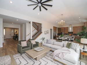 Living room featuring lofted ceiling and light hardwood flooring