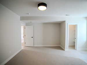 Carpeted empty room featuring a textured ceiling