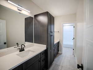 Bathroom with tile patterned floors and vanity