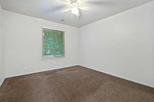 Spare room featuring ceiling fan and carpet floors