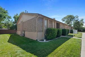 View of side of property featuring a lawn