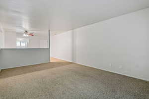 Spare room with light colored carpet and ceiling fan