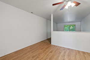 Empty room featuring light hardwood / wood-style flooring and ceiling fan