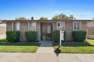 Single story home with a front yard