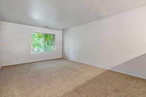 Unfurnished room with carpet flooring