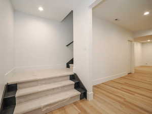 Stairs featuring light hardwood / wood-style flooring