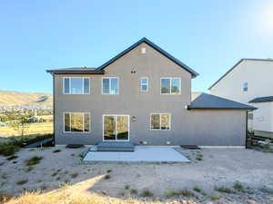 Rear view of property featuring a patio and a mountain view