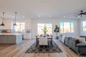 Dining area featuring ceiling fan, sink, and light hardwood / wood-style floors