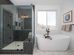 Bathroom featuring tile flooring and separate shower and tub