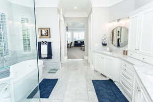 The master bathroom has marble floors, custom cabinets, soaker garden tub and separate Euro shower.