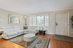 Hardwood floored living room with ornamental molding