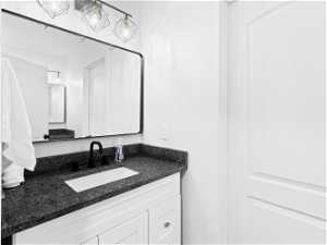 Main level guest  bathroom with two vanities and sinks on opposite sides of the bathroom, tub/shower and toilet.