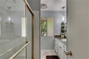 Bathroom with vanity and light tile floors
