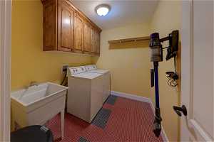 Washroom featuring separate washer and dryer and dark carpet