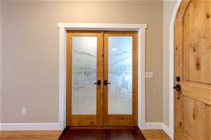 Wood floored entrance foyer with french doors