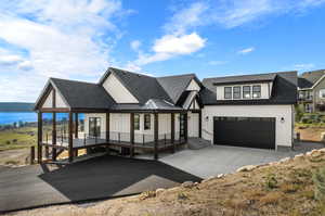 View of front of house with covered porch and a water view