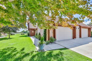 View of front of house with garage and a front lawn