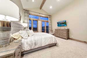 2nd main floor master suite with a high ceiling, vaulted ceiling with beams, and golf course views