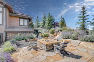 Flagstone patio / terrace with a custom stone firepit