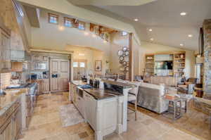 open concept floorplan on main level.  Kitchen open to living, dining room, and bar area.