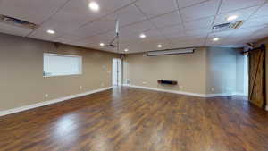 Hardwood floored spare room with a drop ceiling