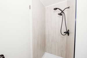 Bathroom featuring a tile shower