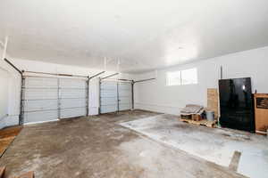 Garage with black refrigerator