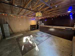 Basement with a fireplace and stainless steel refrigerator