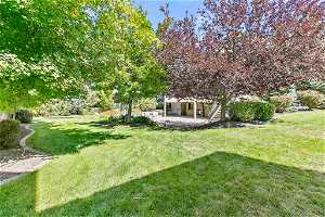 Private fully landscaped yard with mature trees.