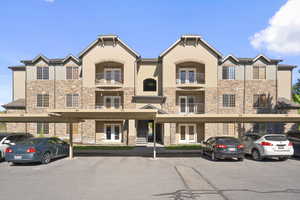 View of front of home featuring balcony and carport