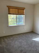 Spare room featuring carpet and a healthy amount of sunlight