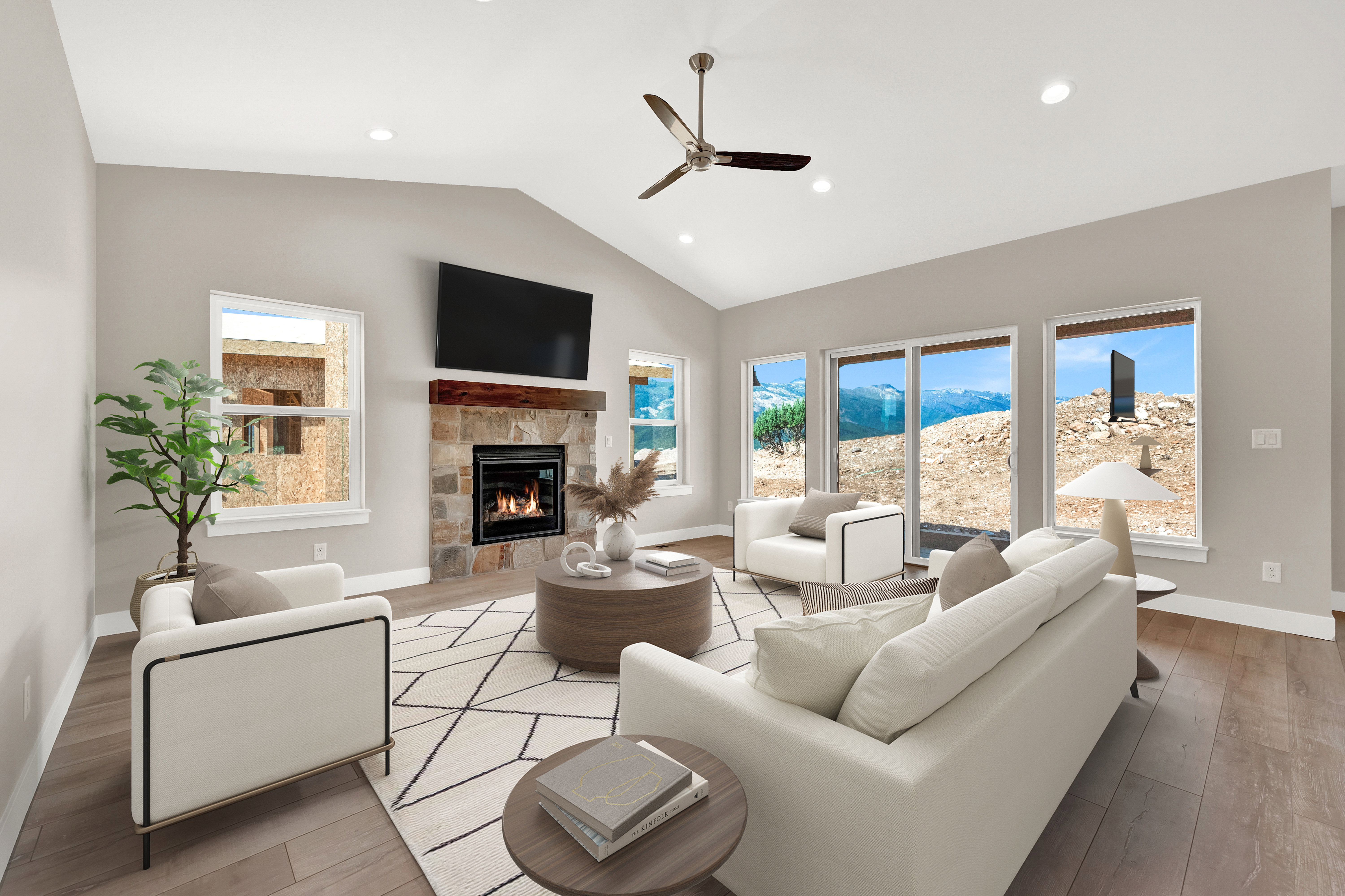 Living room with plenty of natural light, a fireplace, vaulted ceiling, light hardwood floors, and ceiling fan.  Virtually staged.