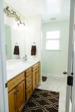 Bathroom featuring mirror and dual large bowl vanity