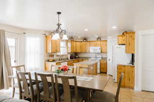 Dining space with a wealth of natural light and light tile floors