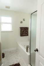 Bathroom featuring separate shower and tub