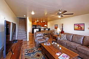 Living room with dark tile floors and ceiling fan