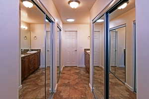 Hall with dark tile flooring