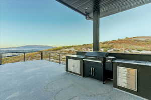 View of patio / terrace featuring balcony, an outdoor kitchen, and a mountain view