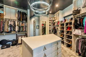 Walk in closet featuring light carpet