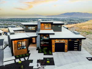 View of front of property with a mountain view and a garage