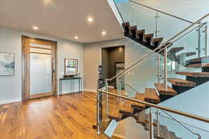 Staircase with light hardwood flooring